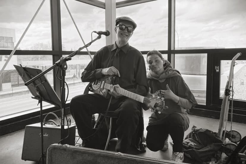 A Lovely Guitar Player and His Follower